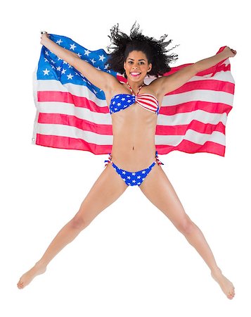 simsearch:400-07181052,k - American girl in bikini leaping holding flag on white background Stock Photo - Budget Royalty-Free & Subscription, Code: 400-07664746