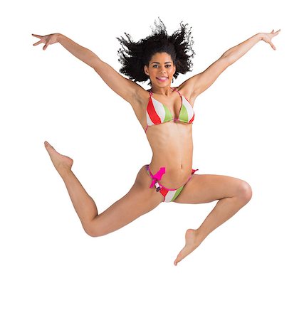 simsearch:400-07181052,k - Fit girl in bikini leaping and smiling at camera on white background Stock Photo - Budget Royalty-Free & Subscription, Code: 400-07664747