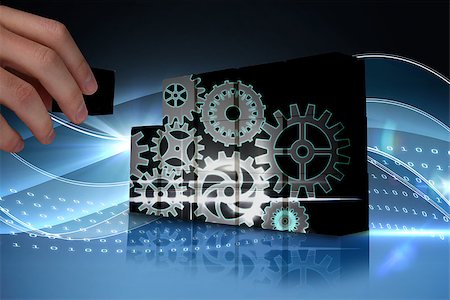 Hand building wall showing cogs and wheels graphic Stock Photo - Budget Royalty-Free & Subscription, Code: 400-07665070