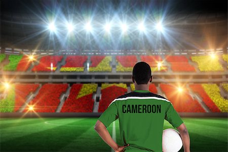 football stadium full crowd pictures - Cameroon football player holding ball against stadium full of cameroon football fans Stock Photo - Budget Royalty-Free & Subscription, Code: 400-07665346