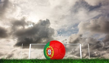 portugal soccer ball - Football in portugal colours against green grass under grey sky Stock Photo - Budget Royalty-Free & Subscription, Code: 400-07665859