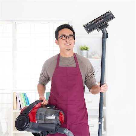simsearch:400-08693600,k - Asian man holding vacuum. House husband doing house chores, house interior. Stock Photo - Budget Royalty-Free & Subscription, Code: 400-07667619