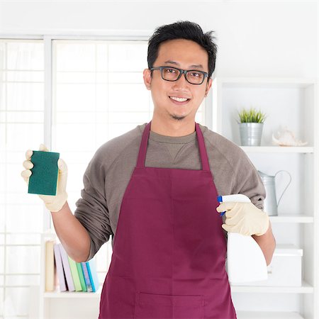 simsearch:400-08693600,k - Asian man holding sponge and spray. House husband doing house chores, with interiors. Stock Photo - Budget Royalty-Free & Subscription, Code: 400-07667620