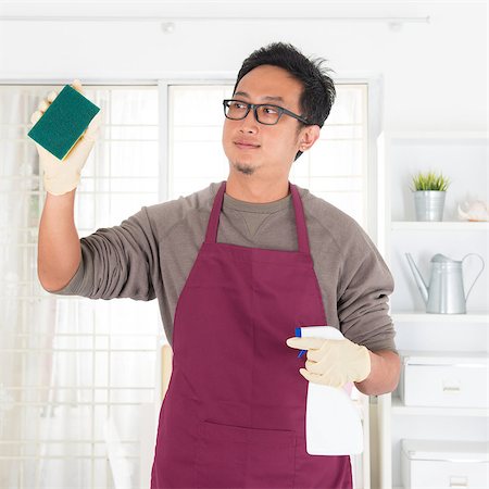 simsearch:400-08693600,k - Asian guy housekeeping. House husband doing house chores, with home interiors. Male model. Stock Photo - Budget Royalty-Free & Subscription, Code: 400-07667622