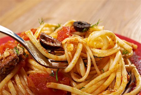 romano - Spaghetti alla puttanesca  salty Italian pasta dish.ingredients are typical of Southern Italian cuisine: tomatoes, olive oil, olives, capers and garlic. Stock Photo - Budget Royalty-Free & Subscription, Code: 400-07669695