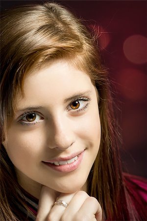 simsearch:400-07509444,k - Studio fashion portrait of young beautiful girl with nice eyes on dark red background Stock Photo - Budget Royalty-Free & Subscription, Code: 400-07660115