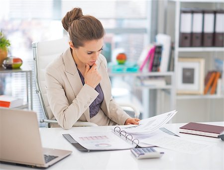 Thoughtful business woman documents in office Stock Photo - Budget Royalty-Free & Subscription, Code: 400-07661094