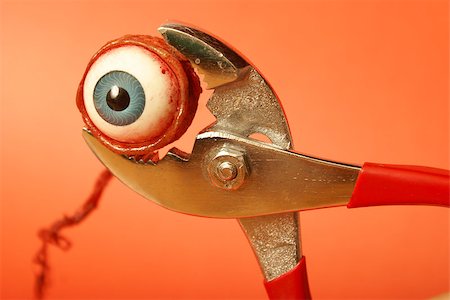 simsearch:400-04751617,k - An eyeball feels the squeeze of a pair of pliers. Stock Photo - Budget Royalty-Free & Subscription, Code: 400-07661809