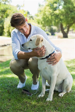 sun dogs - Handsome smiling man with his labrador in the park on a sunny day Stock Photo - Budget Royalty-Free & Subscription, Code: 400-07663763