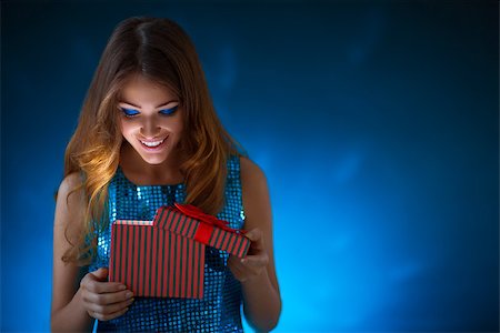 Young attractive girl with a gift Stock Photo - Budget Royalty-Free & Subscription, Code: 400-07679090