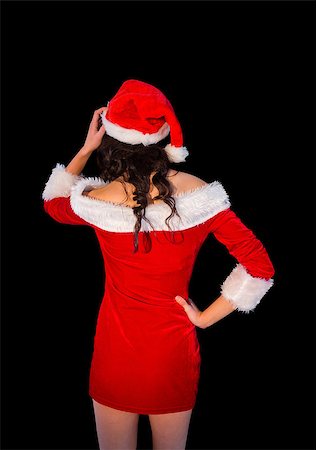 simsearch:693-06435933,k - Thinking brunette in santa outfit posing with hand on hip on black background Stock Photo - Budget Royalty-Free & Subscription, Code: 400-07684212