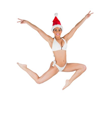 simsearch:400-07181052,k - Fit girl in bikini smiling at camera wearing santa hat on white background Stock Photo - Budget Royalty-Free & Subscription, Code: 400-07684260