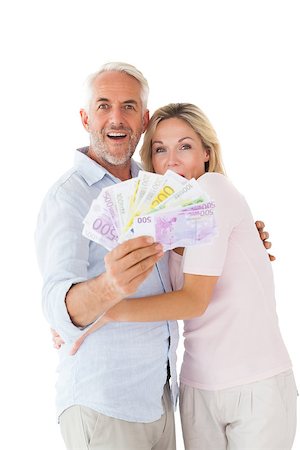 flashing - Happy couple flashing their cash on white background Stock Photo - Budget Royalty-Free & Subscription, Code: 400-07686103