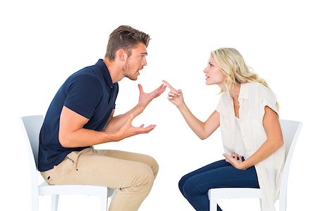 Young couple sitting in chairs arguing on white background Stock Photo - Budget Royalty-Free & Subscription, Code: 400-07686665