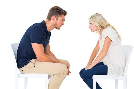 Young couple sitting in chairs arguing on white background Stock Photo - Budget Royalty-Free & Subscription, Code: 400-07686666