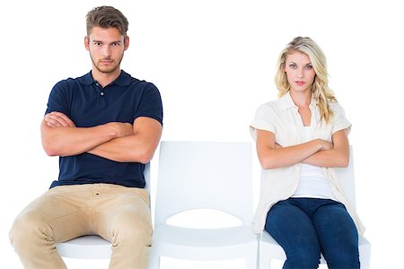 Young couple sitting in chairs not talking during argument on white background Stock Photo - Budget Royalty-Free & Subscription, Code: 400-07686663