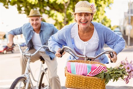 Happy mature couple going for a bike ride in the city on a sunny day Stock Photo - Budget Royalty-Free & Subscription, Code: 400-07687749