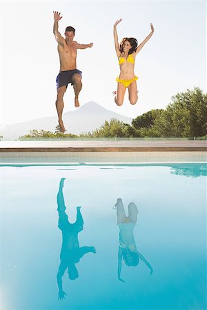 simsearch:400-07181052,k - Full length of a cheerful young couple jumping into swimming pool Stock Photo - Budget Royalty-Free & Subscription, Code: 400-07688291