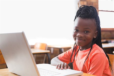 Cute pupil using laptop in classroom at the elementary school Stock Photo - Budget Royalty-Free & Subscription, Code: 400-07688733