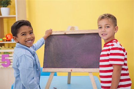 Cute little boys drawing on chalkboard at the nursery school Stock Photo - Budget Royalty-Free & Subscription, Code: 400-07689152