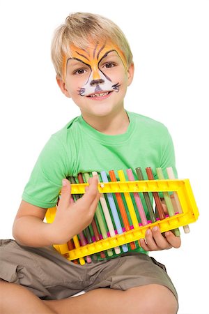 Happy little boy in tiger face paint playing xylophone on white background Stock Photo - Budget Royalty-Free & Subscription, Code: 400-07689310