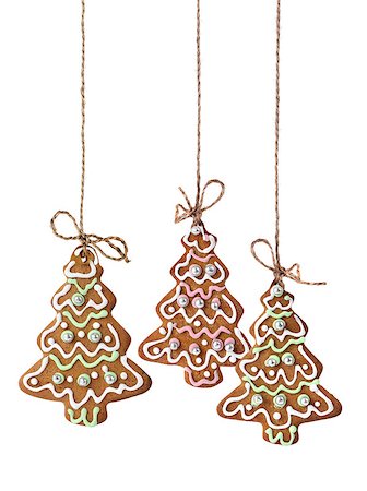 Christmas tree cookies hanging on a natural linen ribbon Photographie de stock - Aubaine LD & Abonnement, Code: 400-07682355