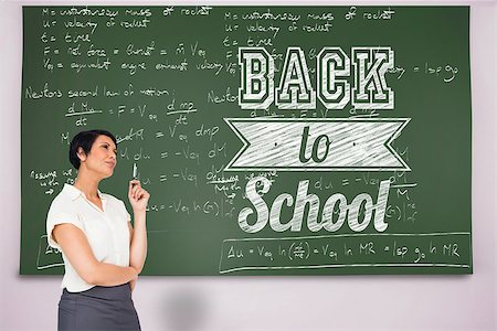 simsearch:400-04917346,k - Thoughtful businesswoman against black chalkboard Stock Photo - Budget Royalty-Free & Subscription, Code: 400-07682870