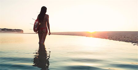 silhouette walking with surfboard - Beautiful surfer girl walking in the beach with her surfboard at sunset Stock Photo - Budget Royalty-Free & Subscription, Code: 400-07714367