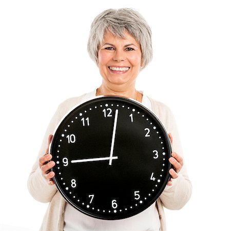 family planning - Elderly woman holding a clock, isoalted on white background Photographie de stock - Aubaine LD & Abonnement, Code: 400-07718356