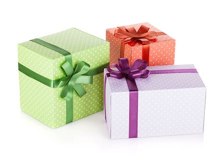 simsearch:400-08806797,k - Three colorful gift boxes with ribbon and bow. Isolated on white background Photographie de stock - Aubaine LD & Abonnement, Code: 400-07719131