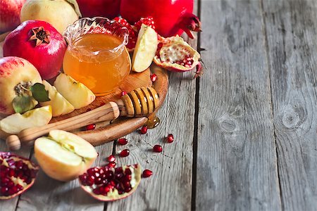 simsearch:400-06069331,k - Pomegranate, apple and honey, traditional food of jewish New Year celebration, Rosh Hashana. Selective focus. Copyspace background Stock Photo - Budget Royalty-Free & Subscription, Code: 400-07719946