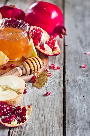 simsearch:400-06069331,k - Pomegranate, apple and honey, traditional food of jewish New Year celebration, Rosh Hashana. Selective focus. Copyspace background Stock Photo - Budget Royalty-Free & Subscription, Code: 400-07719948