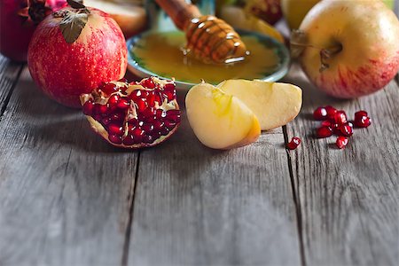 simsearch:400-06069331,k - Pomegranate, apple and honey, traditional food of jewish New Year celebration, Rosh Hashana. Selective focus. Copyspace background Stock Photo - Budget Royalty-Free & Subscription, Code: 400-07719955