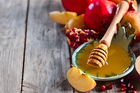 simsearch:400-06069331,k - Pomegranate, apple and honey, traditional food of jewish New Year celebration, Rosh Hashana. Selective focus. Copyspace background Stock Photo - Budget Royalty-Free & Subscription, Code: 400-07719952