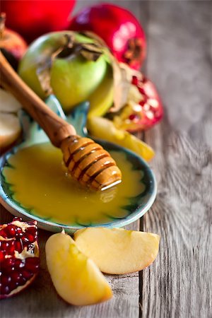 simsearch:400-07329068,k - Pomegranate, apple and honey, traditional food of jewish New Year celebration, Rosh Hashana. Selective focus. Copyspace background Stock Photo - Budget Royalty-Free & Subscription, Code: 400-07719953