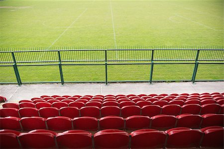soccer arena - Red bleachers looking down on football pitch on a clear day Stock Photo - Budget Royalty-Free & Subscription, Code: 400-07724949