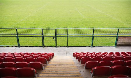 soccer arena - Red bleachers looking down on football pitch on a clear day Stock Photo - Budget Royalty-Free & Subscription, Code: 400-07724950