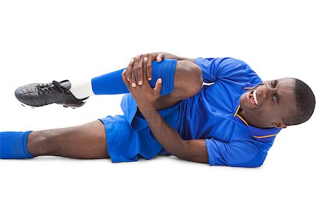 shin - Injured football player lying on the ground on white background Stock Photo - Budget Royalty-Free & Subscription, Code: 400-07725416