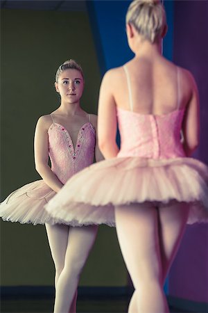 simsearch:400-07725556,k - Graceful ballerina standing in first position in front of mirror in the ballet studio Stock Photo - Budget Royalty-Free & Subscription, Code: 400-07725586