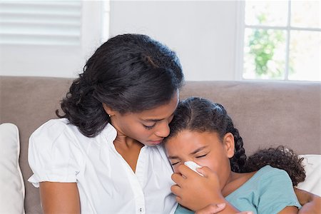 Concerned mother cuddling sick daughter at home in living room Stock Photo - Budget Royalty-Free & Subscription, Code: 400-07726020