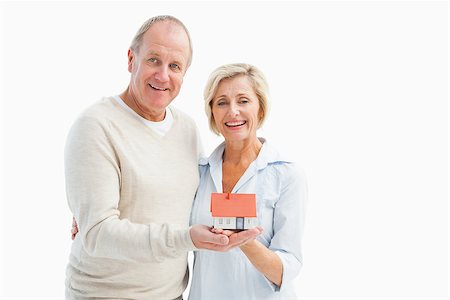 Happy mature couple with model house on white background Stock Photo - Budget Royalty-Free & Subscription, Code: 400-07726530