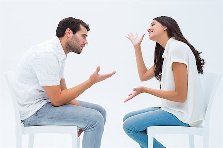 Couple sitting on chairs arguing on white background Stock Photo - Budget Royalty-Free & Subscription, Code: 400-07726743