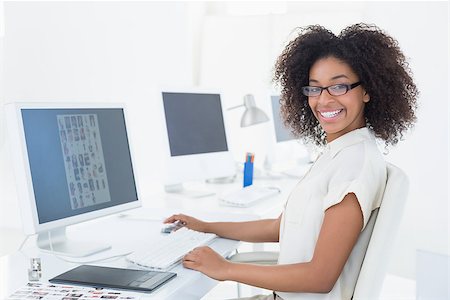 Smiling casual editor working at desk in her office Stock Photo - Budget Royalty-Free & Subscription, Code: 400-07727585