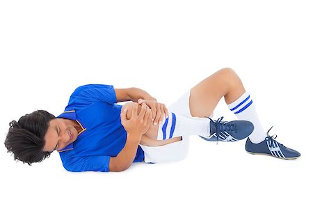 shin - Football player in blue lying injured on white background Stock Photo - Budget Royalty-Free & Subscription, Code: 400-07727922