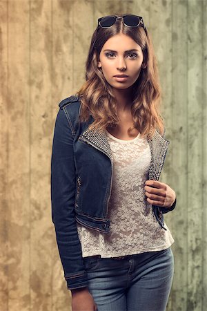 sensual young female with natural wavy hair-style posing with denim fashion clothes and lace white shirt. Trendy sunglasses on the head Stock Photo - Budget Royalty-Free & Subscription, Code: 400-07729670