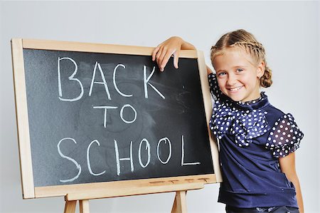 simsearch:695-03381153,k - Smiling cute school girl drawing on blackboard Stock Photo - Budget Royalty-Free & Subscription, Code: 400-07745543