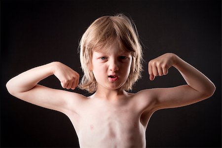 Boy with Blond Hair Showing his Muscles Stock Photo - Budget Royalty-Free & Subscription, Code: 400-07746407