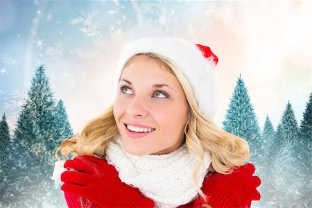 Happy festive blonde against snowy landscape with fir trees Stock Photo - Budget Royalty-Free & Subscription, Code: 400-07755421