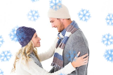 Attractive couple in winter fashion hugging against snowflakes Stock Photo - Budget Royalty-Free & Subscription, Code: 400-07755816