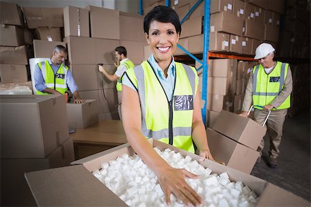 Warehouse workers in yellow vests preparing a shipment in a large warehouse Stock Photo - Budget Royalty-Free & Subscription, Code: 400-07750297